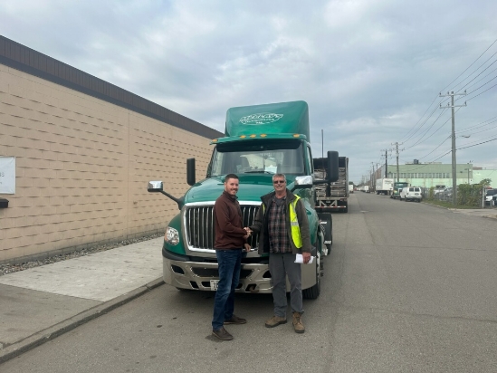 McClay's truck driver shaking a customer's hand