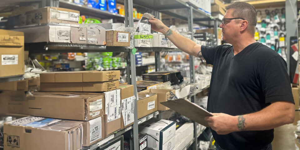 warehouse manager inspecting stock on shelves