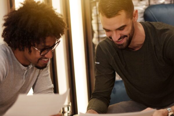 Logistics business owner reviewing a report with a young technologist