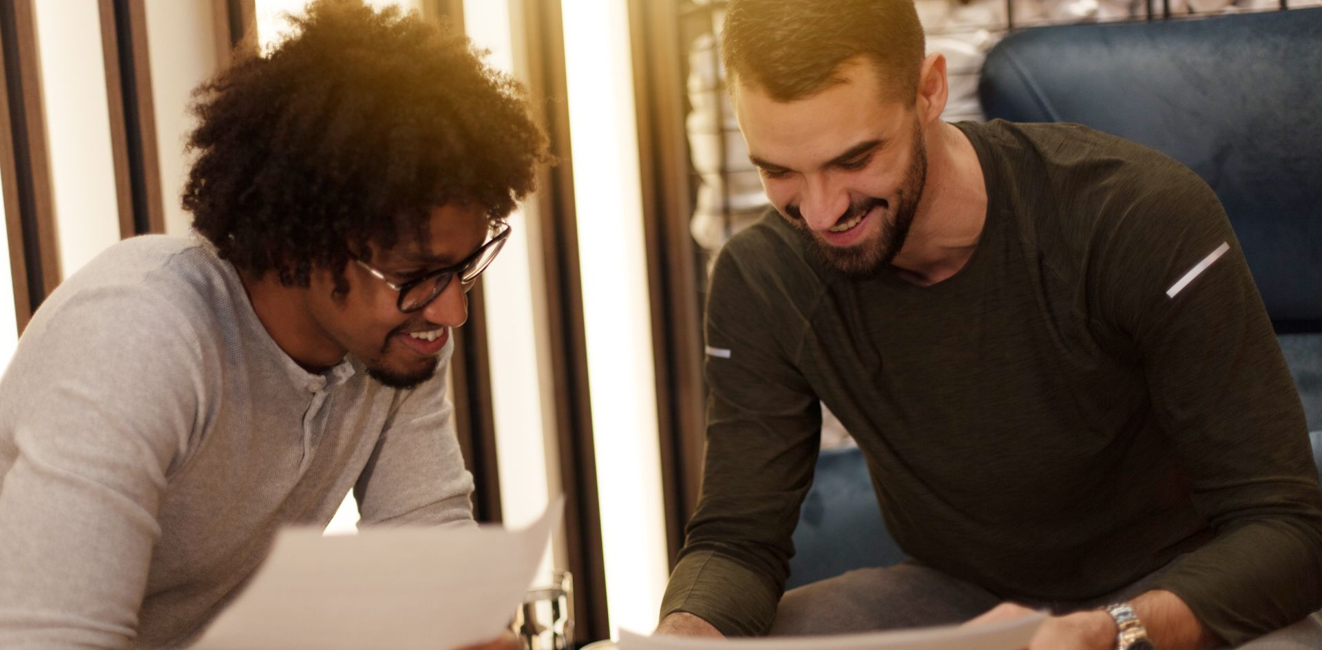 Logistics business owner reviewing a report with a young technologist