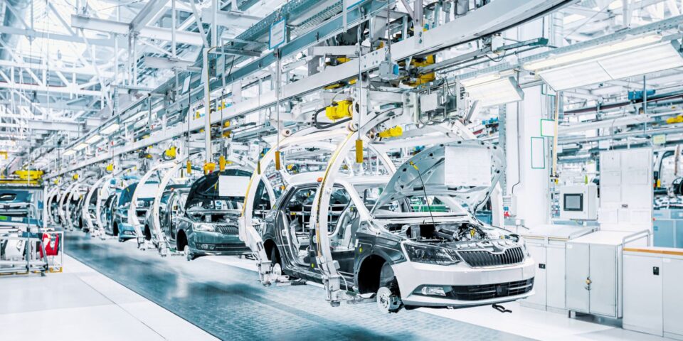 Cars being assembled on a production line at an auto manufacturing plant
