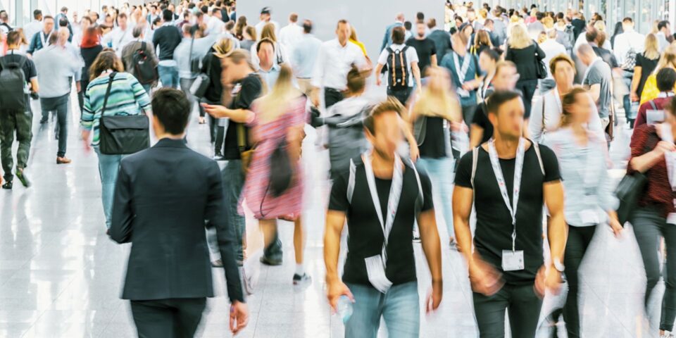 Attendees walking the floor of a trade show